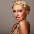 Portrait of a young lady with a braid on grey background